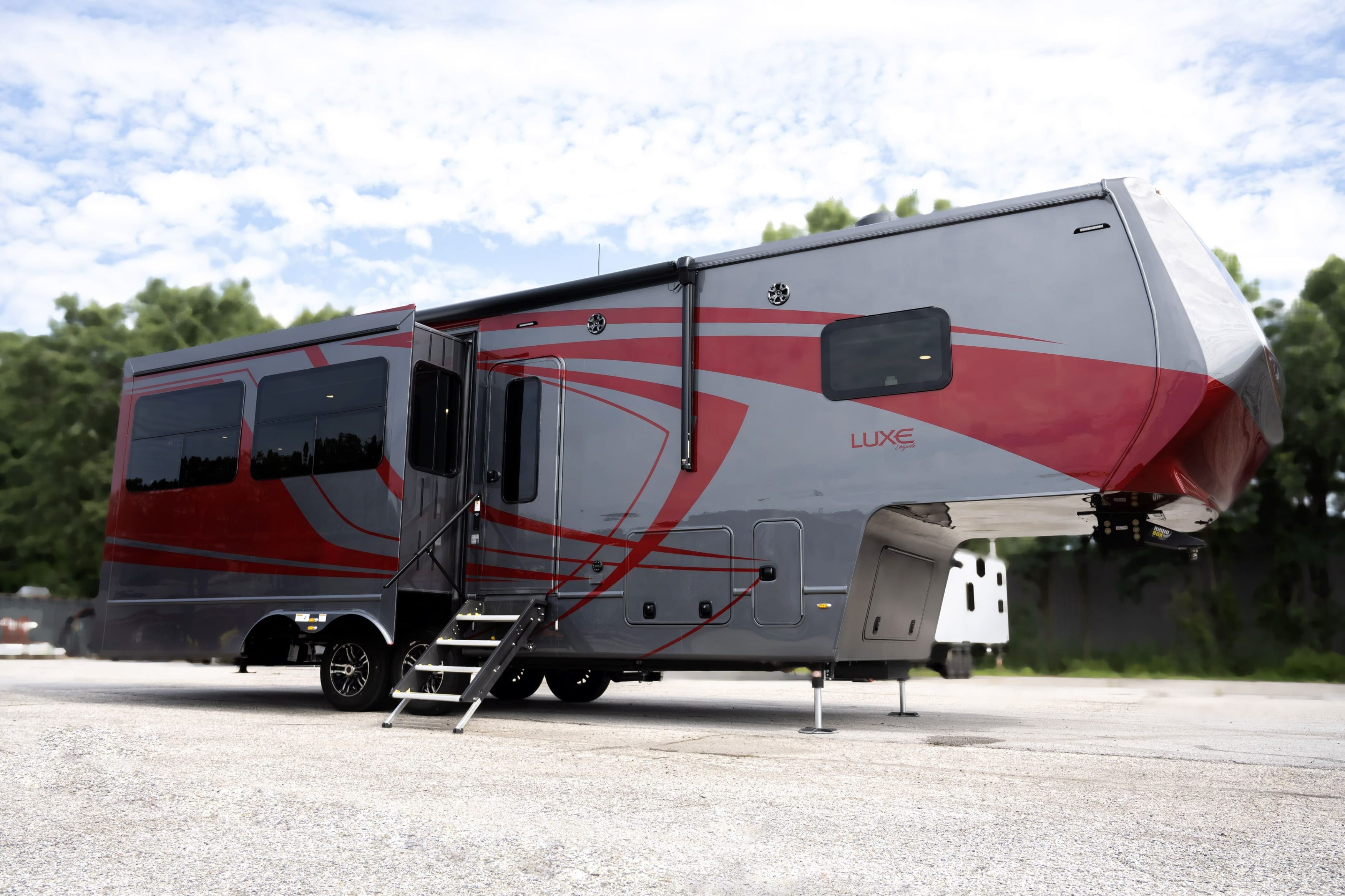 Luxe Elegante 33EFS luxury fifth wheel with red and gray full-body paint and slide-outs