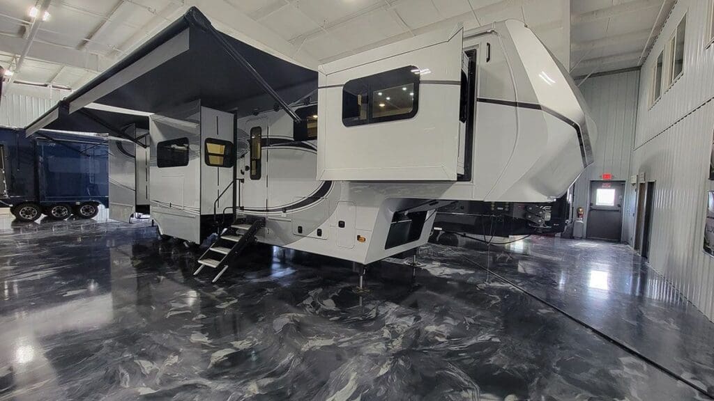 Luxe Elite 44FL luxury fifth wheel RV with front living slide-outs and awning extended