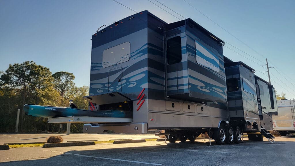 Luxe Elite luxury fifth wheel with full-body paint, slide-outs, and rear kayak storage system