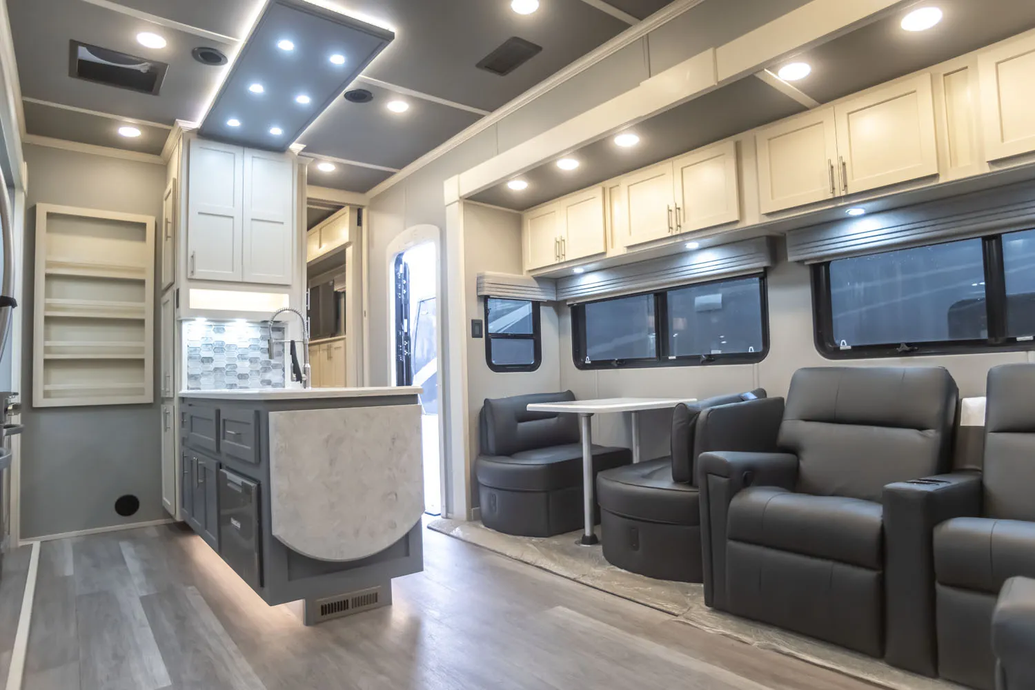 The open living room and kitchen design of a Luxe 5th Wheel Toy Hauler 46FB.