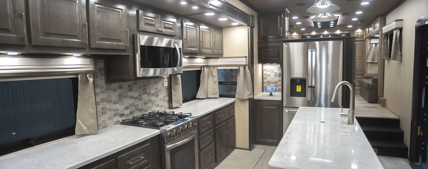 The kitchen of a Luxe Elite Luxury Fifth Wheel with Brazilian cabinetry