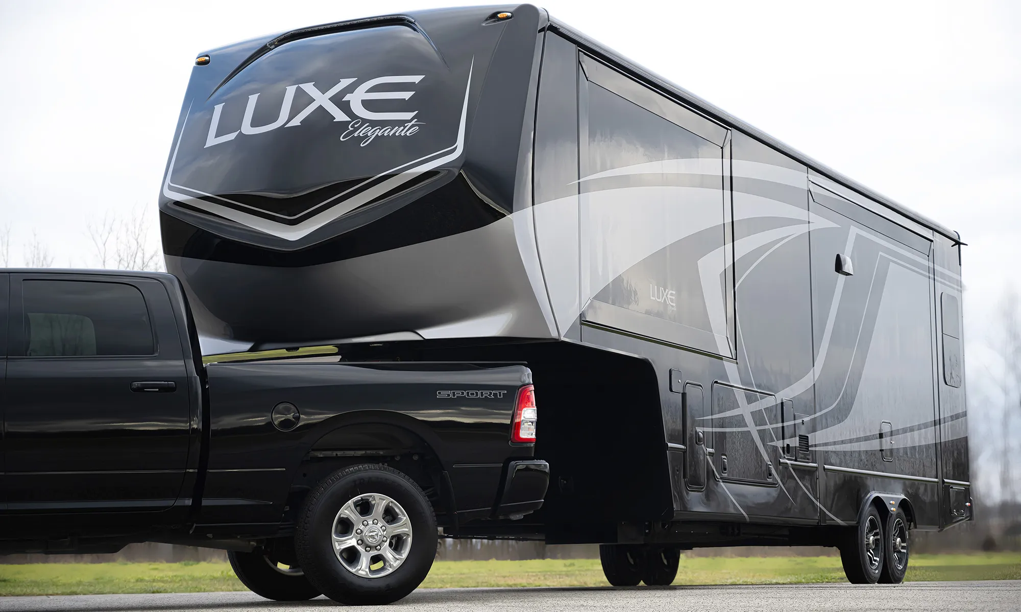 The Luxe Elegante 5th Wheel being towed by a single rear wheel truck.
