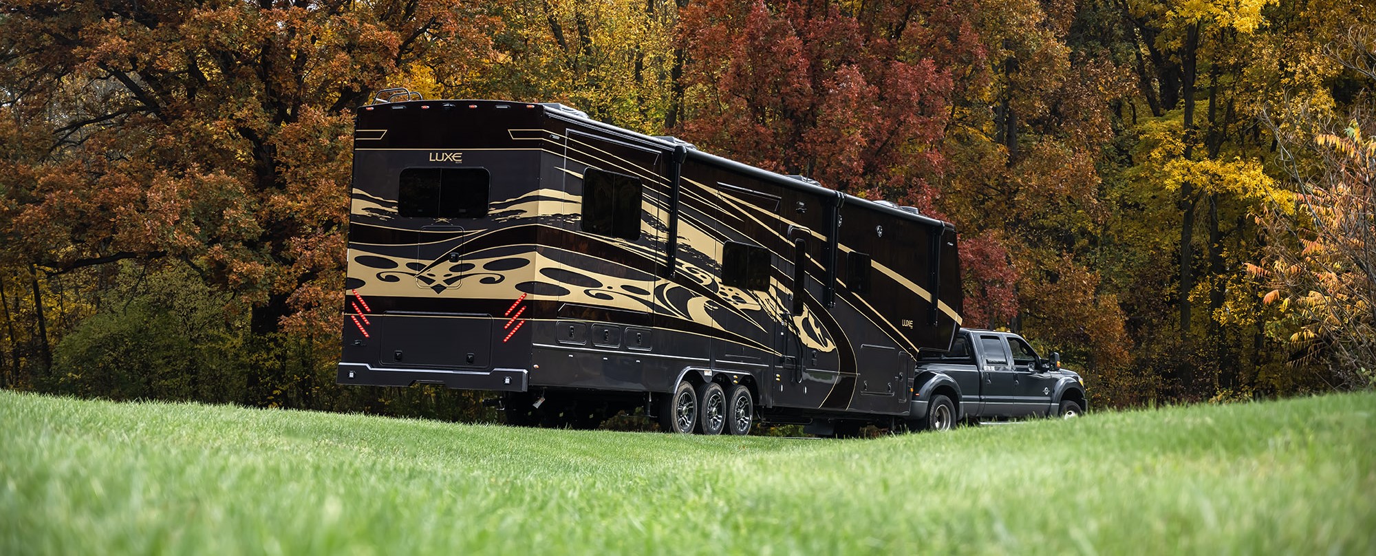 A Luxe Gold Luxury Fifth Wheel hauled by a Luxe Truck Ram 5500 with an air suspension upgrade by Utility Bodywerks.