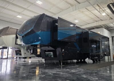 Luxe Toy Hauler 48FB luxury fifth wheel RV with blue full-body paint and slide-outs