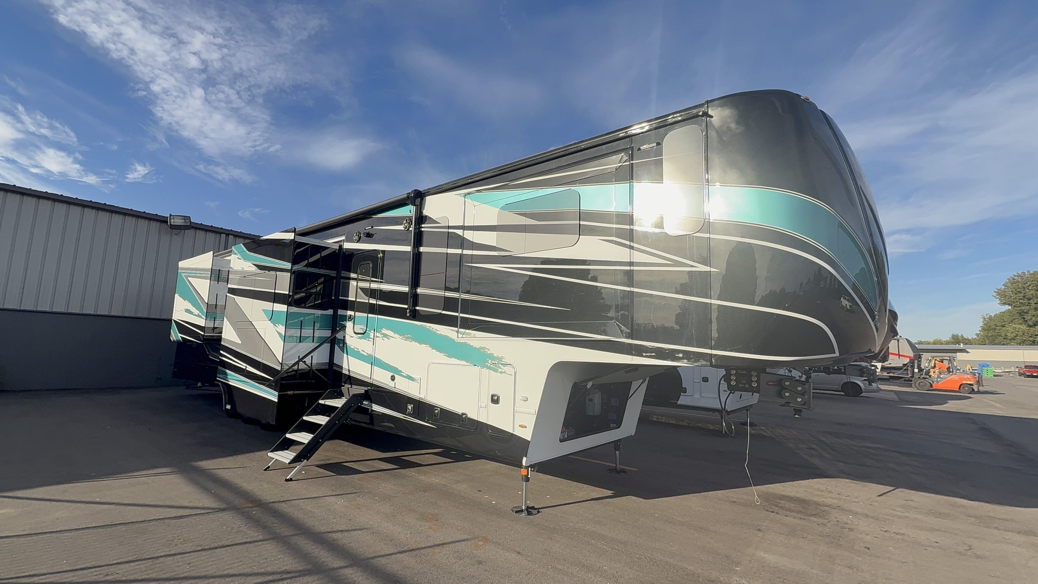 Luxe Regent 48FLB luxury fifth wheel RV with full-body paint and slide-outs parked outdoors