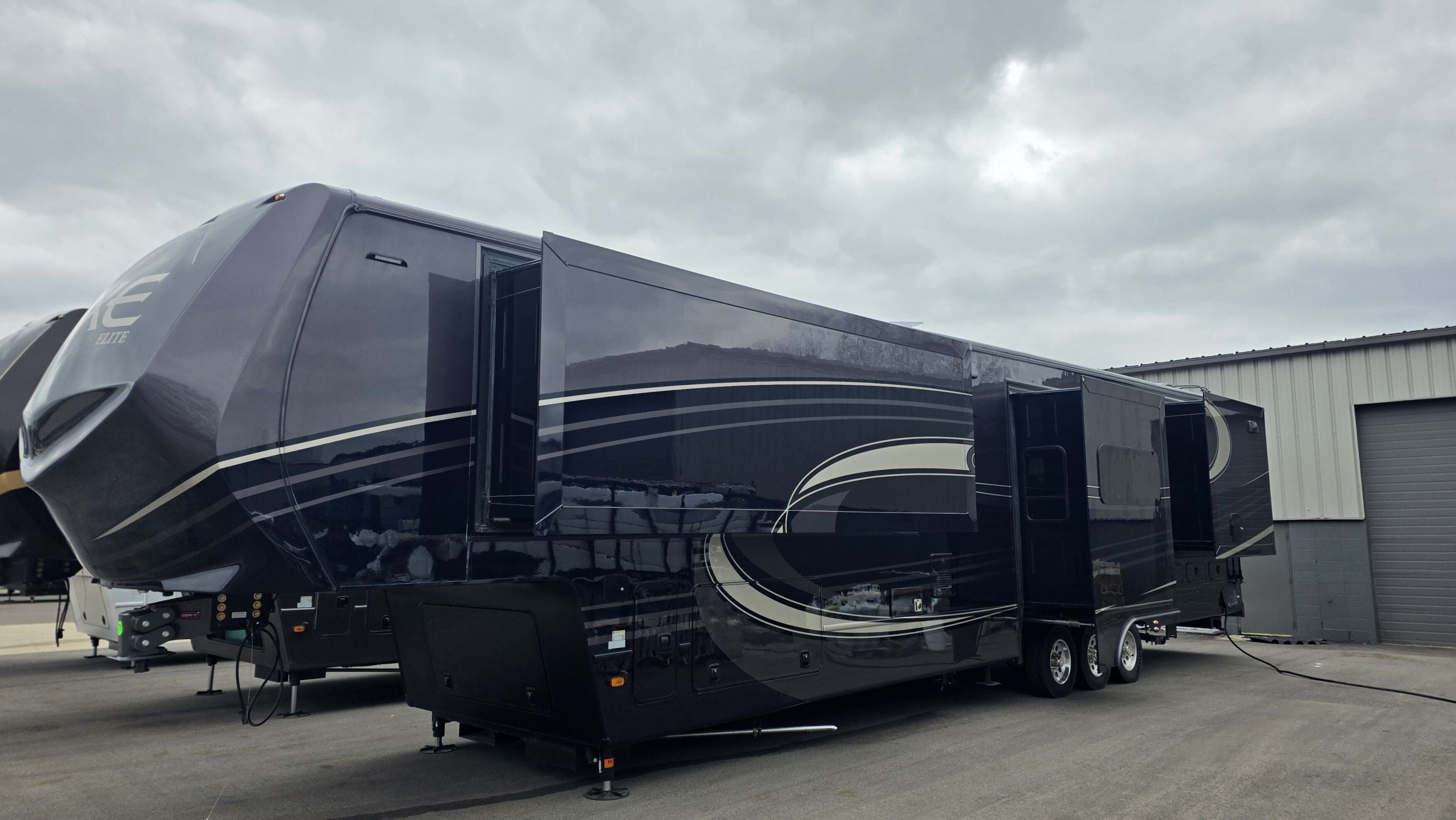 Luxe 46RKB Elite luxury fifth wheel RV with slide-outs extended, full-body paint, and independent suspension