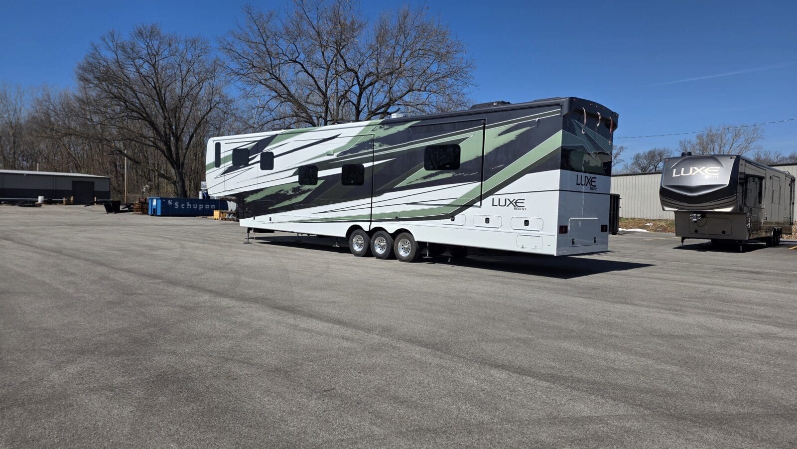 Luxe 48FLB Regent luxury fifth wheel RV with full-body paint and a Luxe Elite in a lot