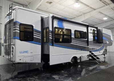Luxe 42RL Elite fifth wheel RV with slide-outs extended, full-body paint, and ladder